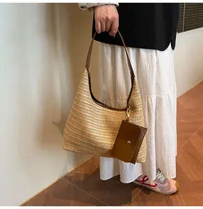 Close-up of straw tote bag with woven texture and a small brown leather coin purse