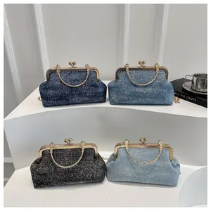 Detailed view of vintage clasp handbags in four blue tones with floral chain handles