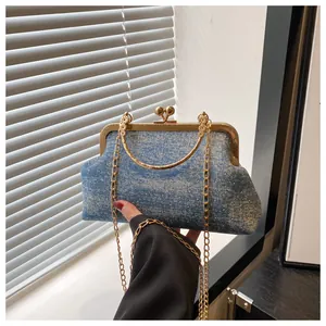 Detail of denim texture evening bag with sparkling rhinestones and gold handle