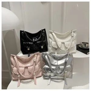 Detail showing high-shine patent leather tote bags with cargo pockets in four stylish colors