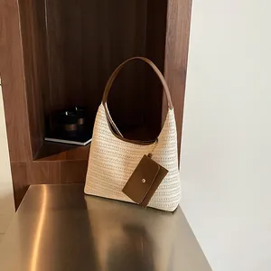Chic cream straw tote bag with brown leather handles and mini pouch accessory