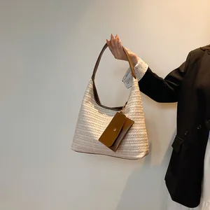 Fashionable large straw tote bag in cream white with brown handles for casual shopping
