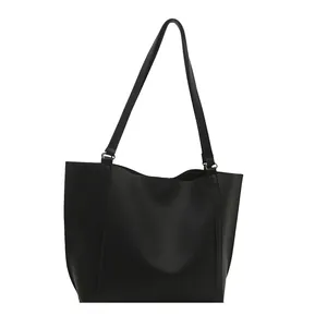 Minimalist black matte tote bag with dual long shoulder straps in a large capacity design