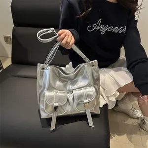 Silver metallic moto tote bag with double front pockets and adjustable crossbody strap