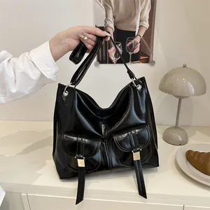 Minimalist black glossy motorcycle tote bag with dual front pockets and metallic buckles