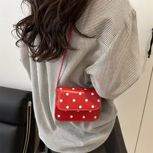 Mini red polka dot crossbody bag for women featuring a stylish flip cover and leather strap