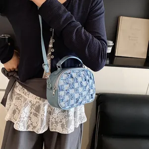 Light blue plaid small handbag with woven fringe texture and adjustable shoulder strap