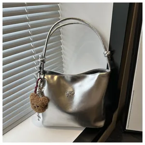 Zilveren metallic shopper met strikdetail, geknoopte riemen en een pluchen beerhanger