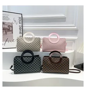 Close-up of four stylish mini handbags in various patterns on a modern display