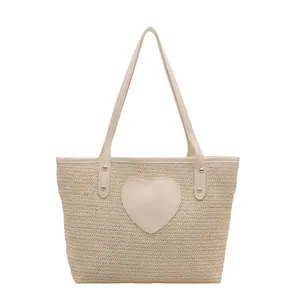 Minimalist straw bucket tote bag with heart patch and leather handles for summer