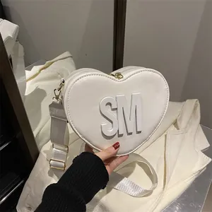Minimalist white heart-shaped crossbody bag with SM logo and wide fabric strap