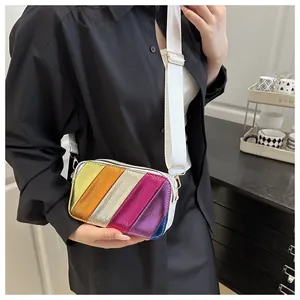 Detail of colorful metallic striped camera bag with a wide white fabric shoulder strap