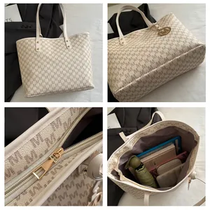 Detail view of cream tote bag featuring letter print, zipper closure, and spacious interior