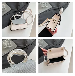 Detail view of mini leather handbag featuring liquid metal handle and magnetic closure