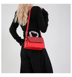 Model back view of red leather crossbody bag with silver handle and glitter flap
