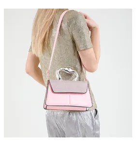Detail of pink crossbody bag with silver liquid metal handle and glitter flap decoration