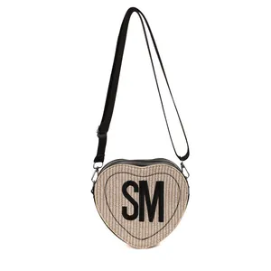 Beige straw heart-shaped crossbody bag with black trim and SM letter embroidery