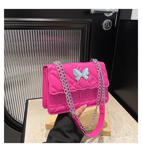 Detail of fuchsia quilted bag with silver butterfly clasp and fashion lettering