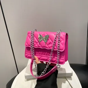 Rose pink quilted chain shoulder bag featuring a metallic butterfly clasp and embossed design