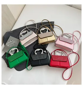 Detailed collection of mini glitter flap bags with unique wavy metal top handles and straps