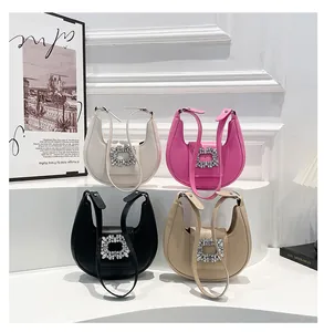Detail of crescent handbags with crystal buckles in white, pink, black and beige