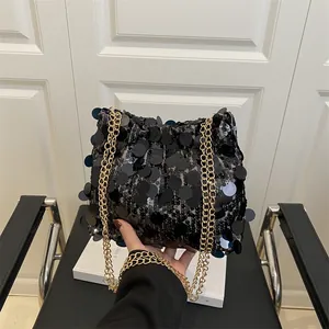 Silver sequin shoulder bag with golden double chain straps in a stylish French design