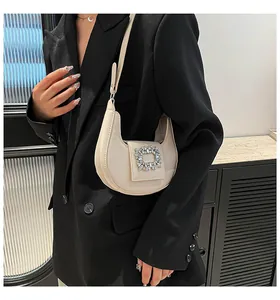 Detail of hobo shoulder bag with luxury crystal square buckle and smooth cream leather