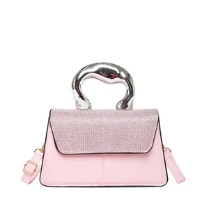 Pink crossbody bag with sparkly sequined flap and unique twisted silver metal handle