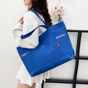 Minimalist navy blue canvas tote bag for men and women featuring a large capacity design