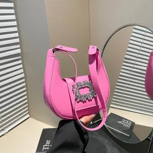 Pink hobo handbag with sparkling rhinestone buckle and wide shoulder strap