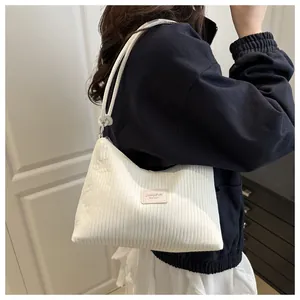 Détail du sac à bandoulière en velours côtelé blanc avec étiquette JINGPIN