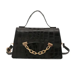 Fashionable black crocodile embossed box handbag with decorative gold chain and strap
