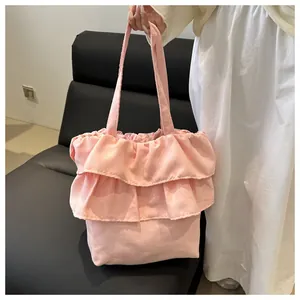 Detail showing pink tiered ruffle layers and soft fabric texture on a ballet-style tote bag