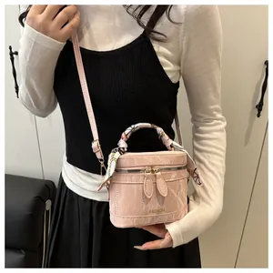 Pink marble pattern PU leather mini bucket bag with scarf handle shown on shoulder