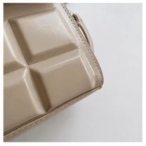 Detail view of premium cream quilted leather texture and high-quality stitching on bag