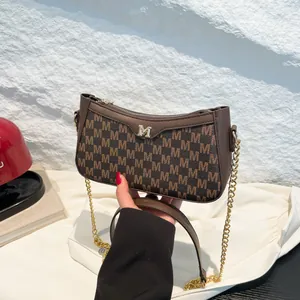 Vintage brown monogram shoulder bag with metallic M buckle and chain strap for women