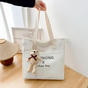 Vintage cream canvas tote bag with letter print and brown plush bear charm