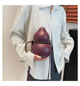 Detailed view of a dark purple gourd-shaped shoulder bag with woven rope detailing