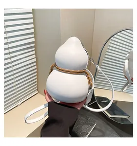 Close-up of white gourd-shaped leather crossbody bag with woven rope detail and thin strap