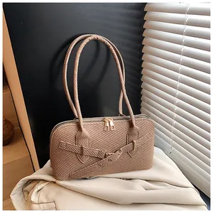 Close-up of brown woven texture and gold double zipper detail on women pillow bag