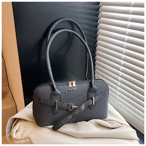 Detail of dark grey woven texture handbag with golden hardware and twin zipper closure