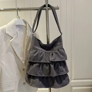 Borsa tote in velluto grigio scuro con design a balze appesa alla gruccia