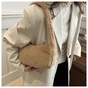 Detailed close-up of brown faux fur texture and stitching on a fluffy shoulder bag