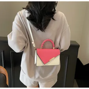 Crossbody view of fashion small square bag with color-block flap and gold metal hardware