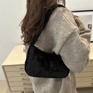 Chic black faux fur baguette shoulder bag worn by model in a minimalist stylish setting
