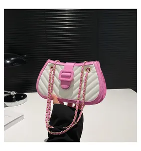 Detail of pink and white patchwork shoulder bag with V-quilted texture and gold chain strap