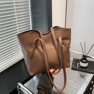 Minimalist large brown leather tote bag for women with adjustable straps for commuting