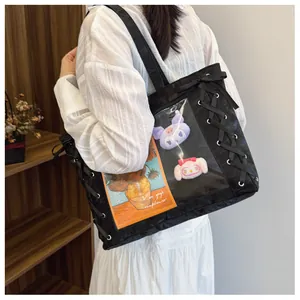 Detail of black ita bag with transparent window, ribbon lacing and large tote capacity