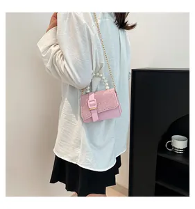 Detailed shot of pink sequin mini bag with pearl handle and metal chain strap