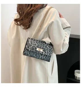 Détail de la chaîne dorée et du fermoir sur le sac à main à motif léopard chic